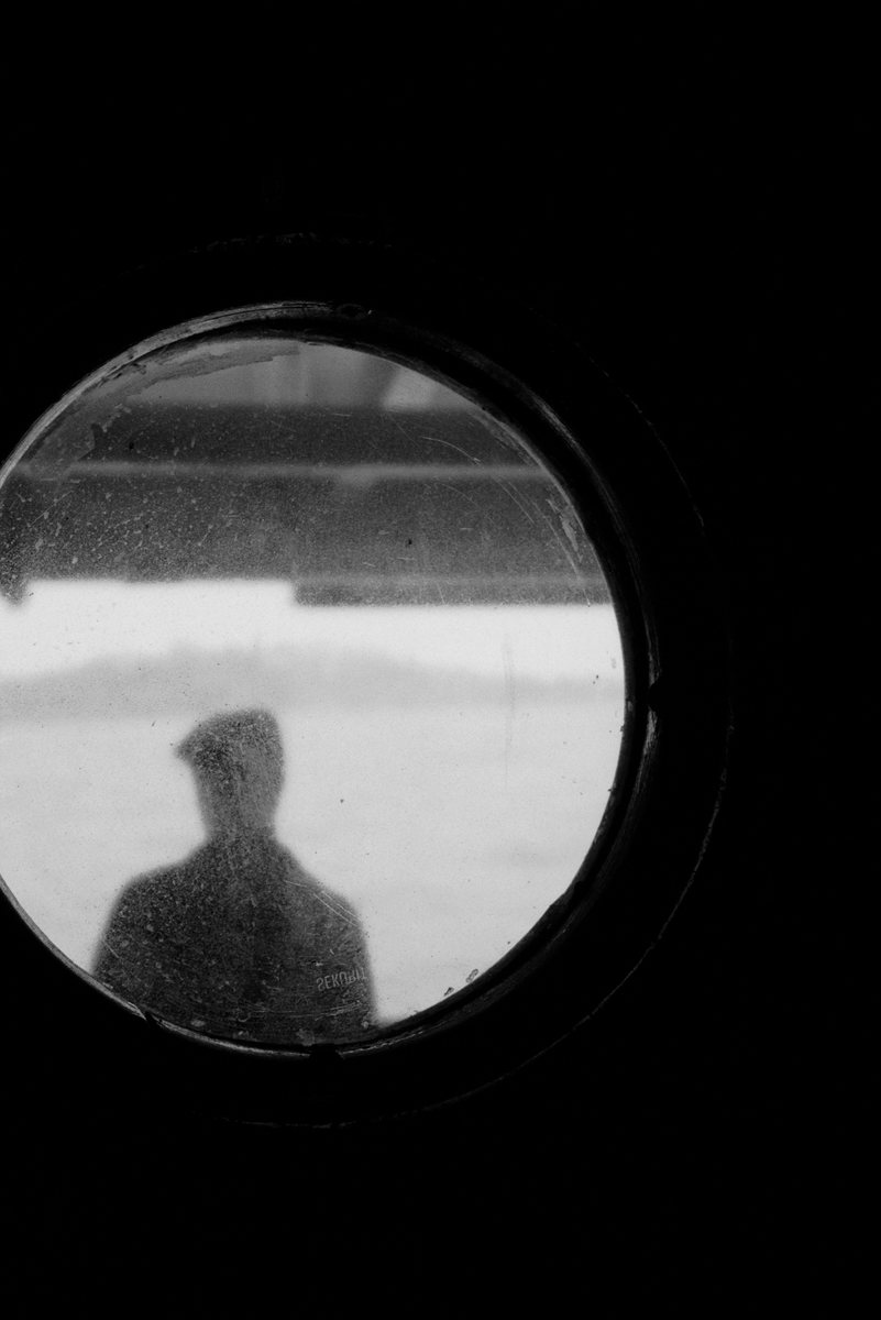 Man in the porthole of a Bosphorus ferry.