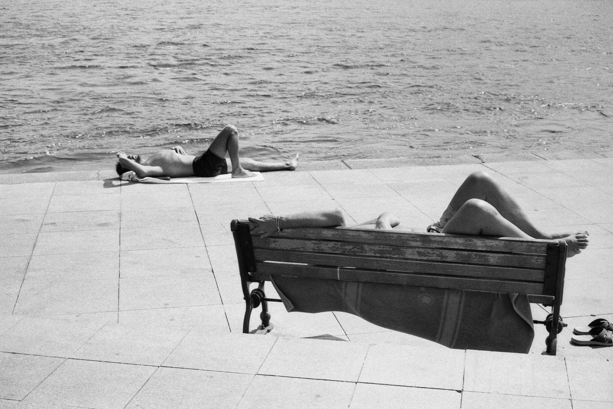 Men resting under the Sun. Arnavutköy.